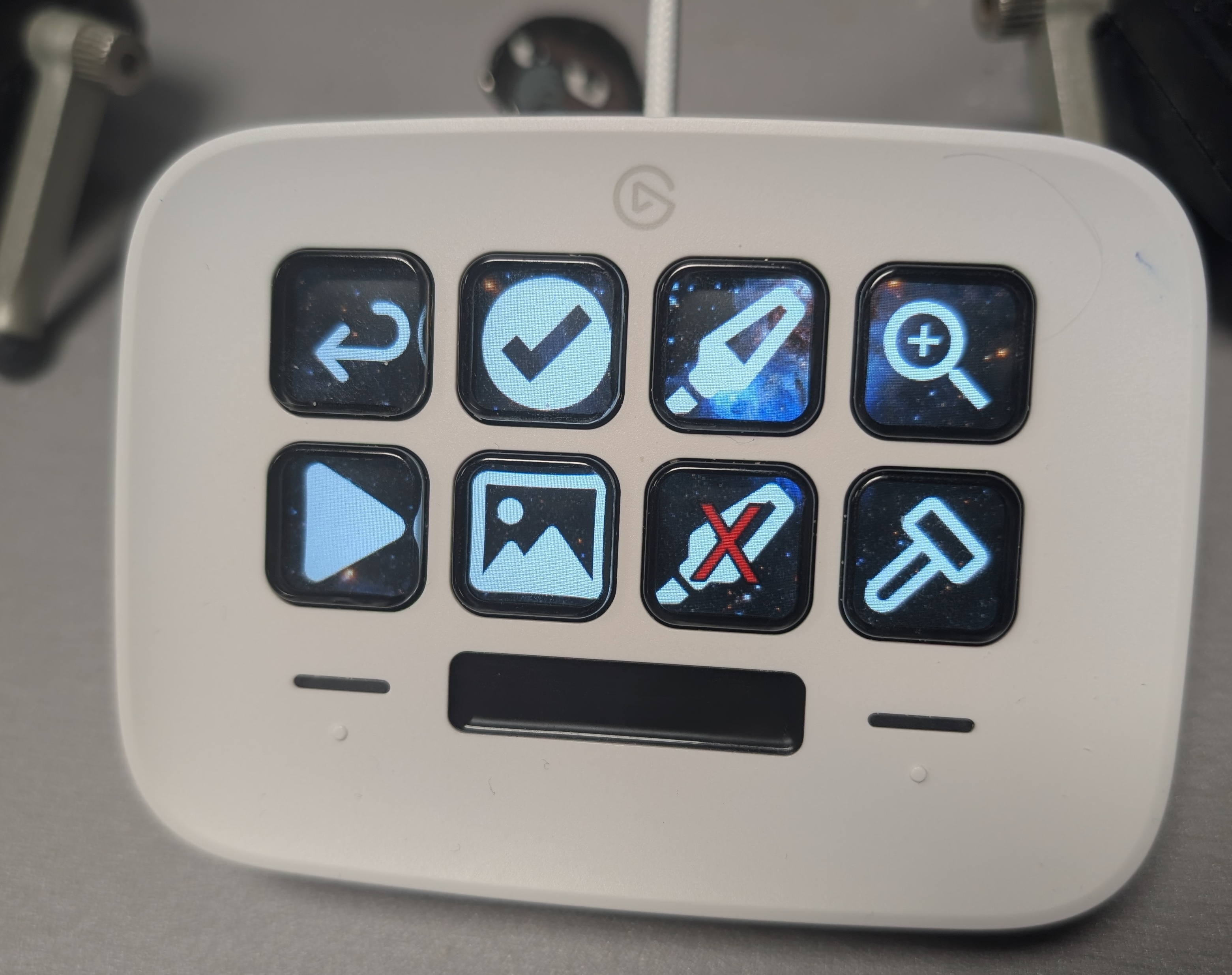 Picture of my configured Streamdeck Neo on my desk, between my two keyboard halves.